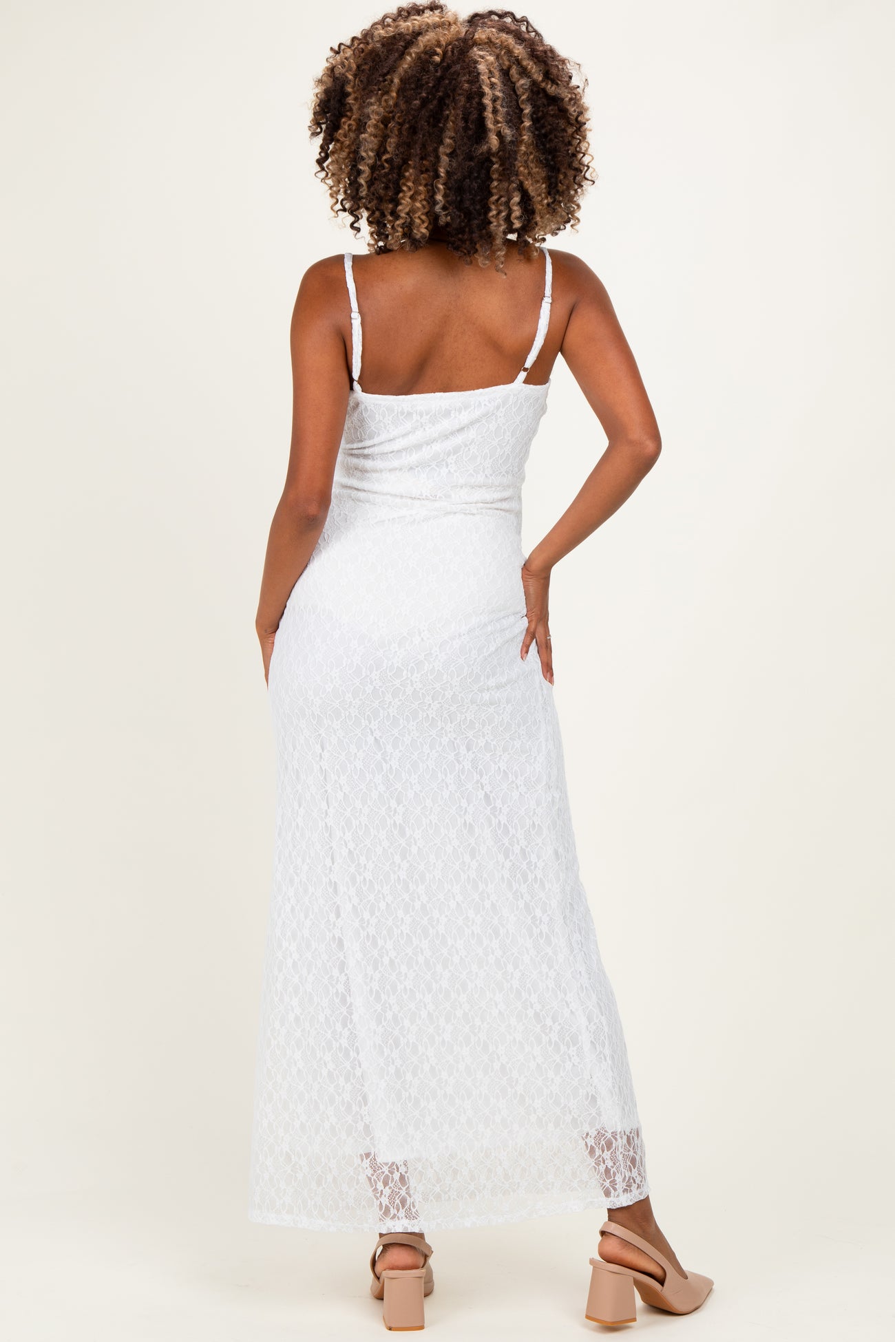 woman wearing a white lace maternity maxi dress with adjustable straps, showing the back view