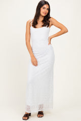 woman wearing a white lace maxi dress with thin straps and a fitted silhouette