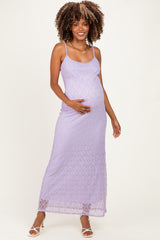 woman wearing a lavender lace maternity maxi dress and holding her baby bump