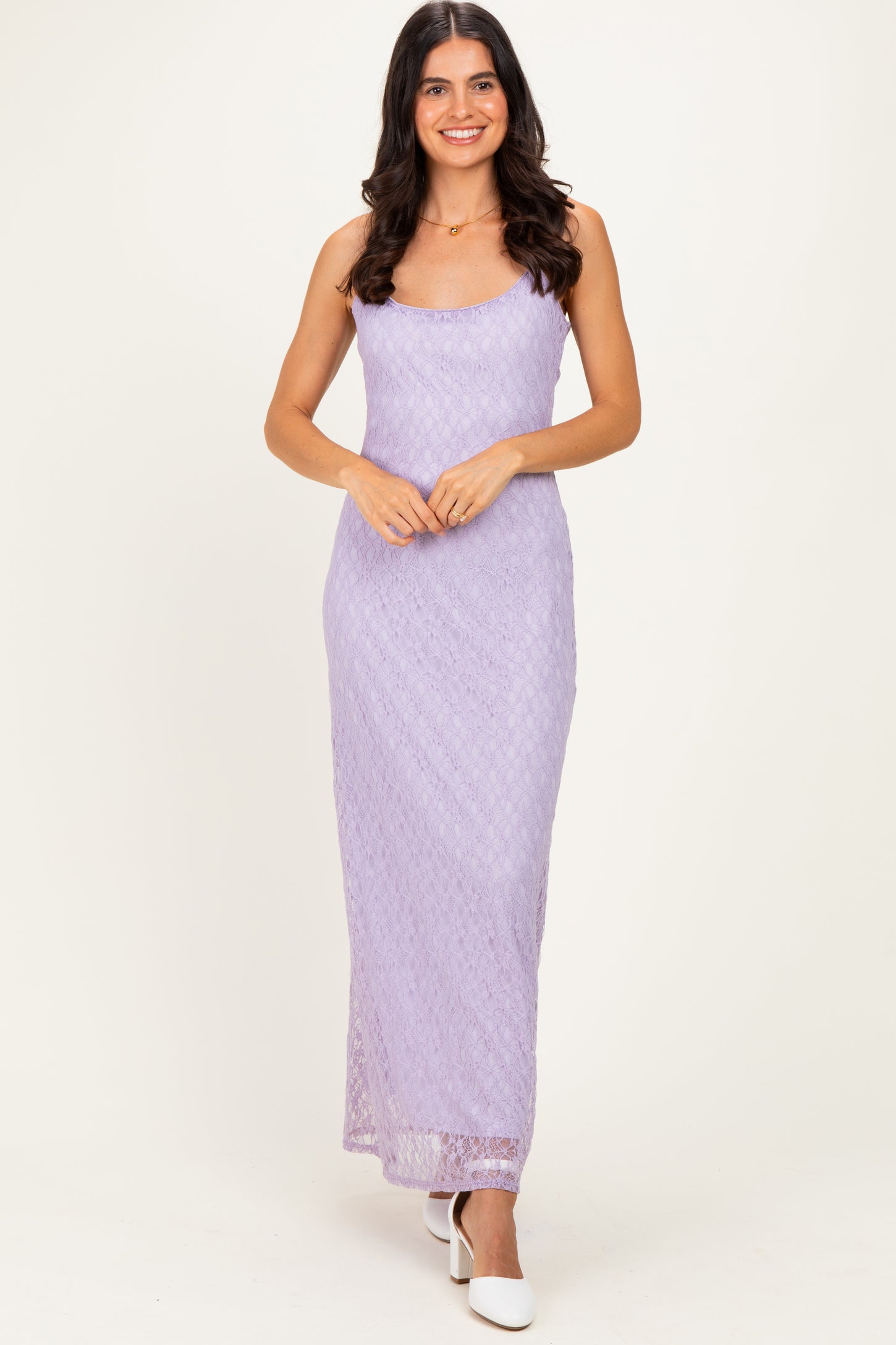 woman wearing a lavender spaghetti strap maxi dress with a textured pattern and a fitted silhouette