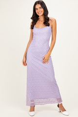 woman wearing a lavender lace maxi dress with spaghetti straps and a fitted silhouette