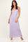 woman wearing a lavender lace maxi dress with spaghetti straps and a fitted silhouette