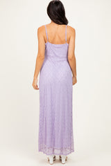 woman wearing a lavender lace maxi dress with spaghetti straps, showing a fitted silhouette from the back