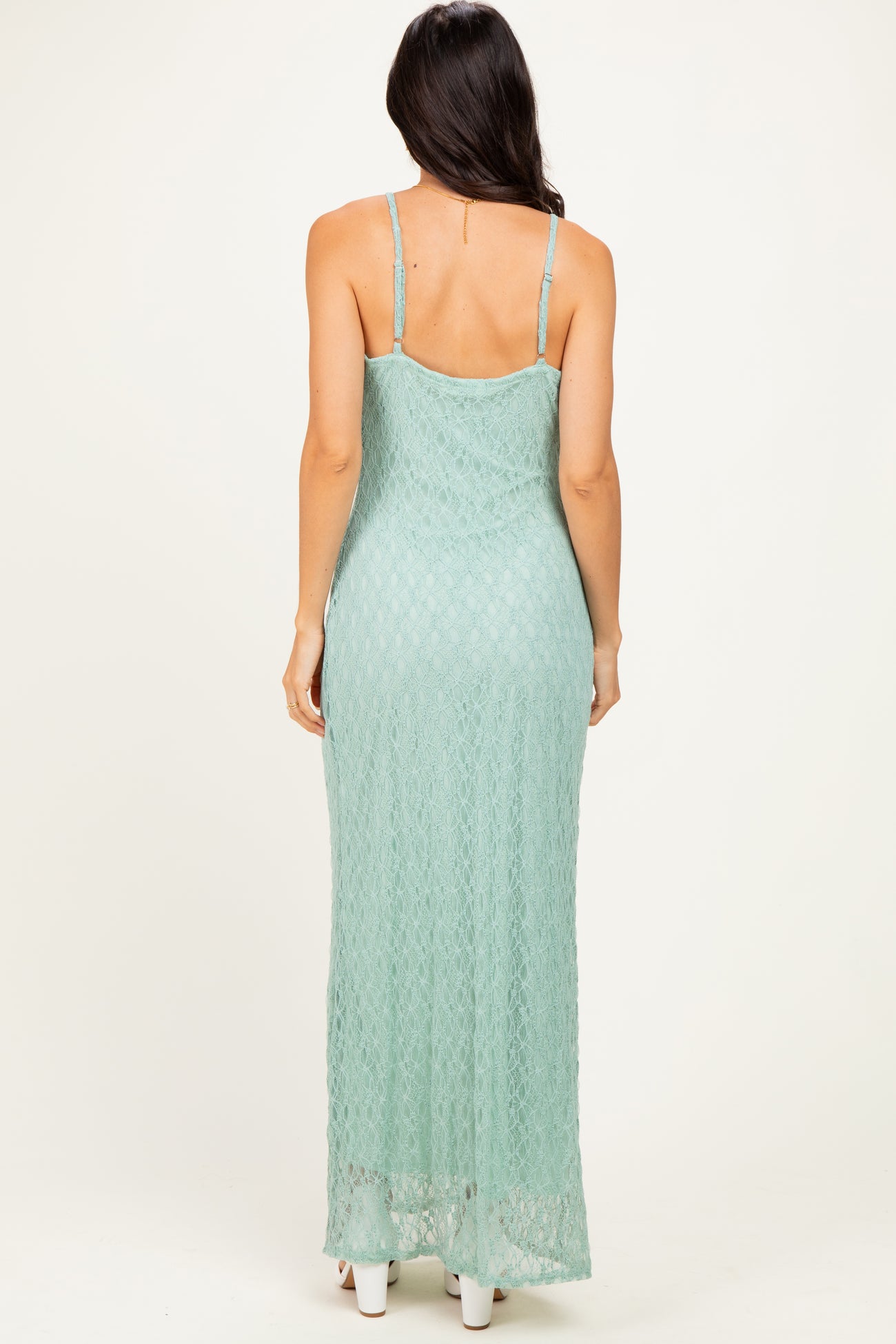 woman wearing a back view of a mint green lace maxi dress with adjustable straps
