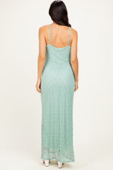 woman wearing a back view of a mint green lace maxi dress with adjustable straps