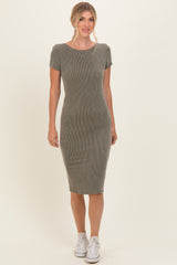 woman wearing a short sleeve olive green ribbed midi dress and white sneakers