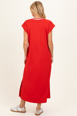 woman wearing a red maternity maxi dress with short sleeves and side slits, showing a relaxed fit