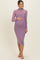 woman wearing a light purple long sleeve maternity dress with a high neck and baby bump visible