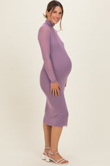woman wearing a lavender long sleeve maternity dress with a fitted silhouette and a visible baby bump