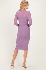 woman wearing a fitted lavender long sleeve dress with a mesh overlay, showing a sleek silhouette from the back