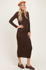 woman wearing a brown long sleeve ribbed maxi dress with a fitted silhouette and a tan beret