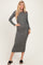 woman wearing a long sleeve gray bodycon midi dress and black slide sandals