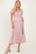 woman wearing a pink puff sleeve maxi dress with a smocked bodice and side pockets