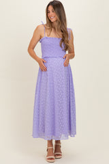 woman wearing a lavender maternity dress with smocked bodice and adjustable straps, showcasing her baby bump