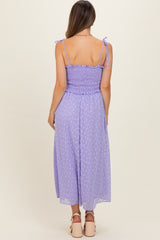 woman wearing a lavender smocked back maxi maternity dress with tie straps and polka dot pattern