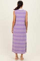 woman wearing a long purple striped sleeveless maxi dress with a side slit, viewed from the back