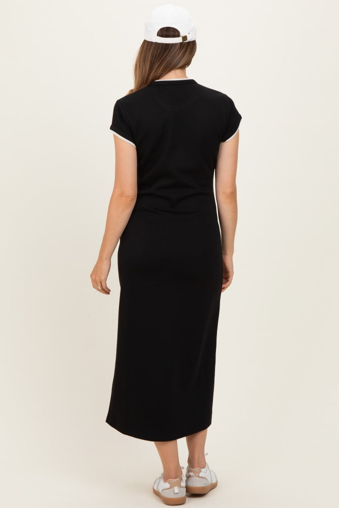 woman wearing a black maternity maxi dress with short sleeves and a long silhouette, viewed from the back