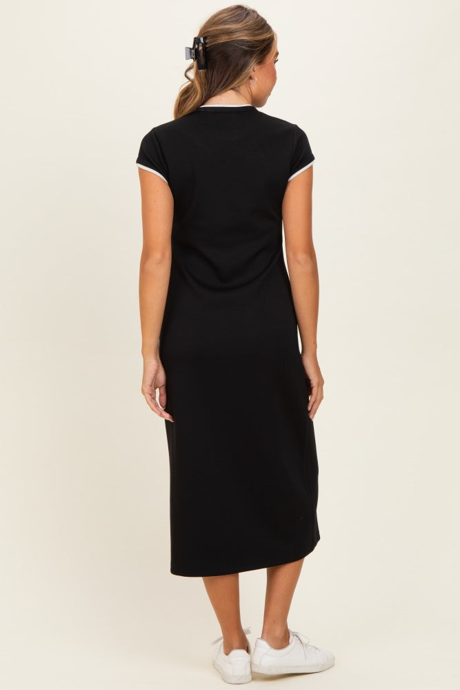 woman wearing a black midi dress with short sleeves and a sleek design, viewed from the back