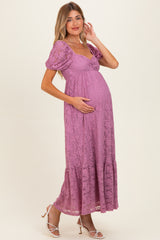 woman wearing a lilac lace maternity maxi dress and holding her baby bump