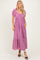woman wearing a lilac lace maxi dress with puff sleeves and a v-neckline