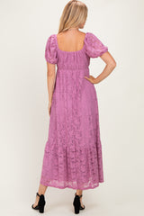 woman wearing a lilac lace maxi dress with puff sleeves and a tiered skirt, viewed from the back
