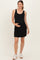 woman wearing a black sleeveless maternity dress and holding her baby bump