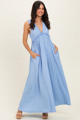 woman wearing a light blue sleeveless maxi dress with a v-neck and side pockets