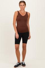 woman wearing a brown sleeveless v-neck tank top and black bike shorts