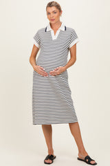 woman wearing a navy and white striped maternity polo dress with a visible baby bump