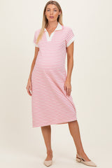 woman wearing a pink and white striped short sleeve maternity polo dress with a collar and a baby bump visible