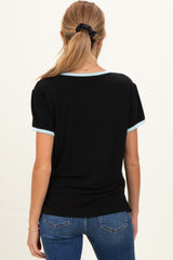 woman wearing a black maternity top with light blue trim, seen from the back, paired with blue jeans