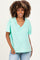 woman wearing a mint green maternity v-neck t-shirt with a relaxed fit and short sleeves