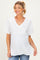 woman wearing a white v-neck maternity top with short sleeves and a baby bump visible