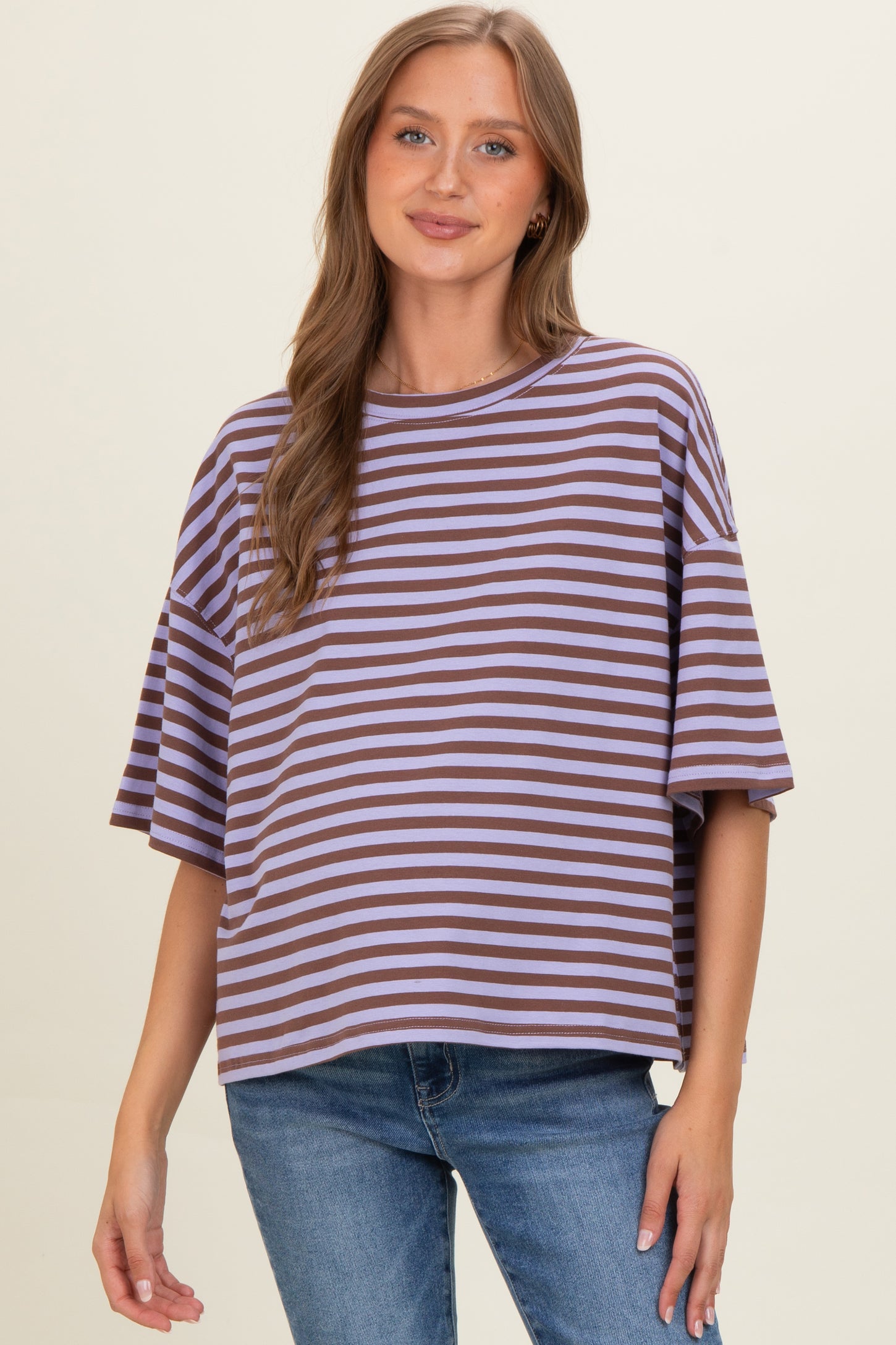 woman wearing a striped purple and brown maternity top with a relaxed fit