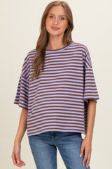 woman wearing a striped purple and brown maternity top with a relaxed fit