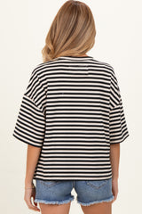 woman wearing a black and white striped oversized maternity top with short sleeves and back detail