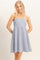 woman wearing a strapless blue and white striped sundress with a fitted bodice and flared skirt