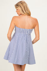 woman wearing a navy and white striped strapless maternity dress with a smocked back panel