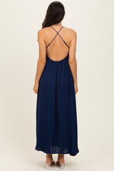 woman wearing a navy blue maxi dress with a crisscross back design