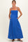 woman wearing a bright blue maternity maxi dress with smocked bodice and pockets, featuring spaghetti straps and a flowing skirt