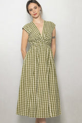 woman wearing a green and white checkered midi dress with a twisted bodice and cap sleeves
