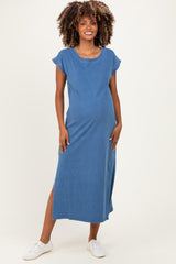 woman wearing a blue maternity maxi dress with short sleeves and side slits, displaying a visible baby bump