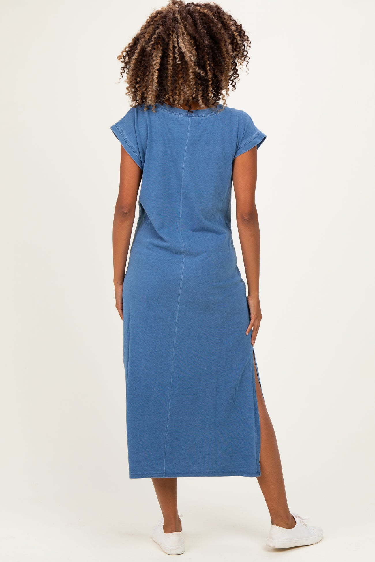 woman wearing a blue maternity maxi dress with short sleeves and side slits, showing a flattering fit from the back
