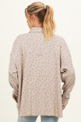 woman wearing a light beige floral patterned maternity cardigan with a relaxed fit and long sleeves