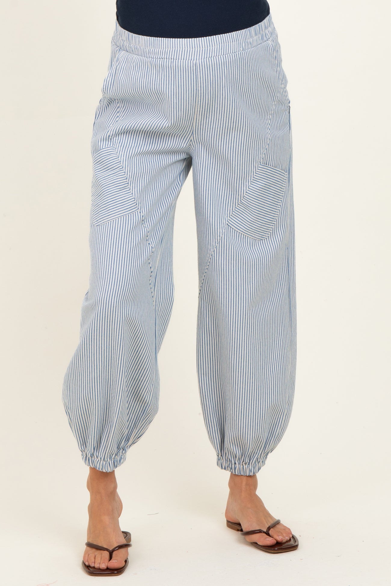 woman wearing blue and white striped maternity pants with elastic cuffs and pockets
