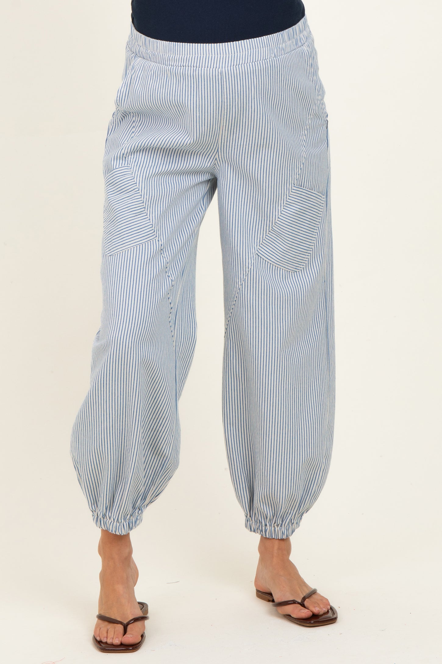 woman wearing blue and white striped maternity pants with elastic cuffs and pockets
