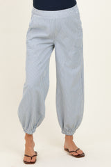 woman wearing blue and white striped maternity pants with elastic cuffs and pockets