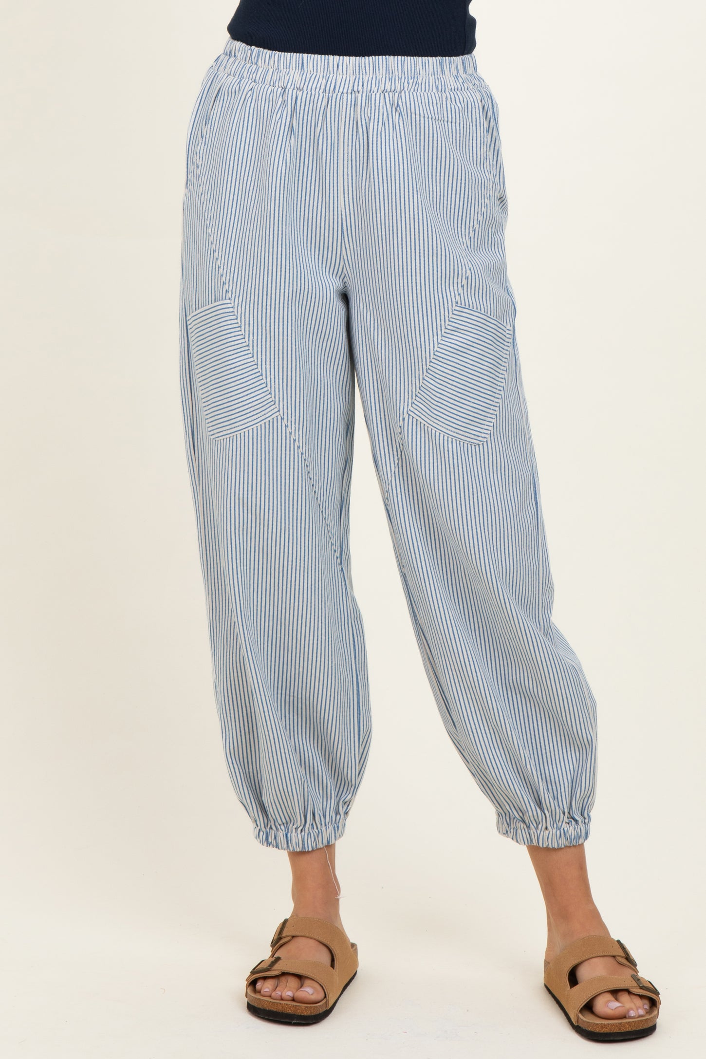 woman wearing light blue striped jogger pants with elastic waistband and side pockets