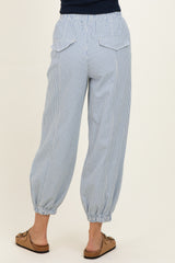 woman wearing light blue striped jogger pants with elastic waistband and cuffed ankles, showing back view