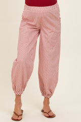 woman wearing red and white striped maternity pants with elastic waistband and relaxed fit